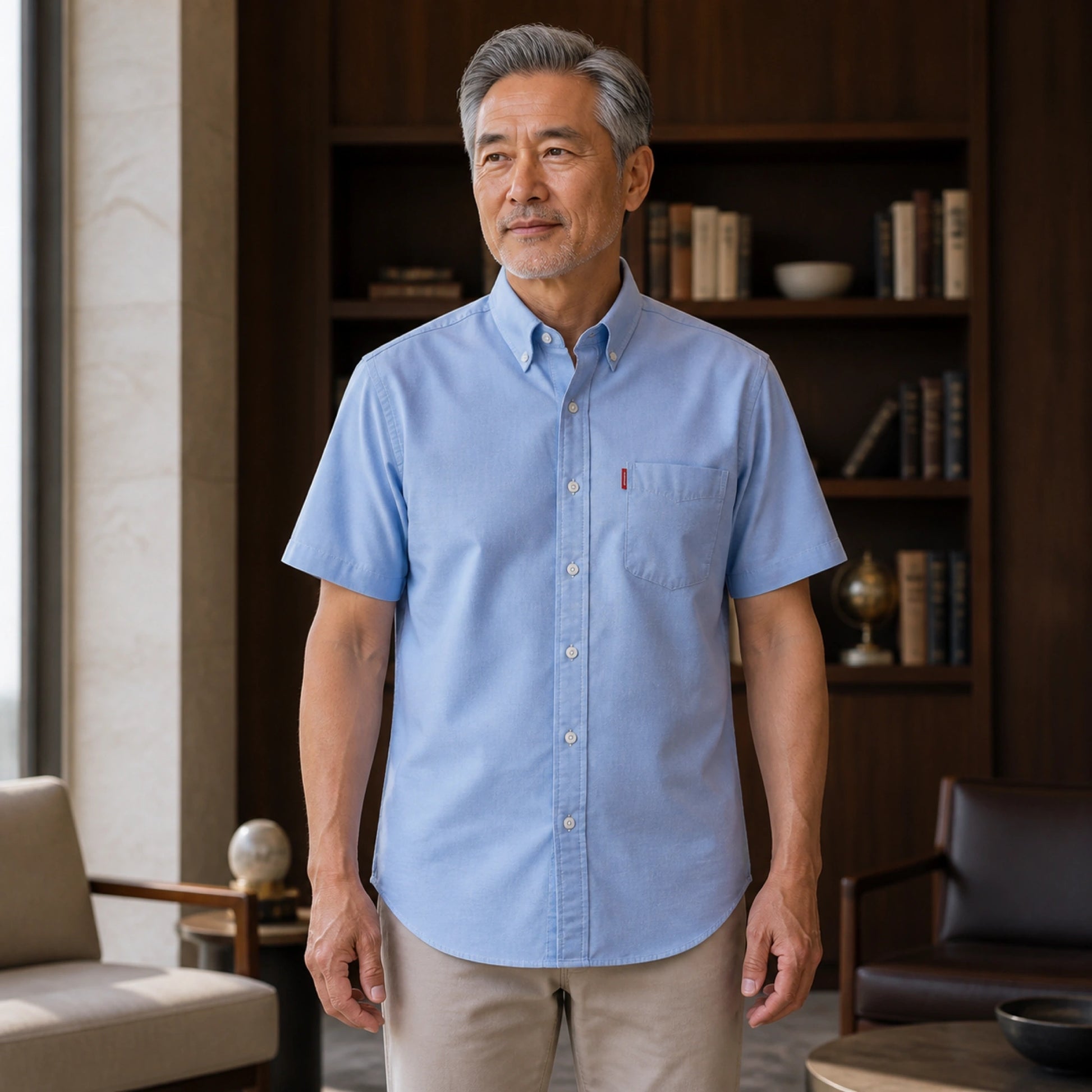 Mature man wearing Blue classic fit short sleeve Oxford shirt, full front view with button down collar, chest — view 3