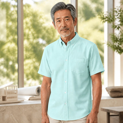 Mature man wearing the green short sleeved Oxford shirt, full visible in a bright design — view 3
