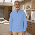 Mature man wearing Blue long sleeve casual Oxford shirt, full front view with button down collar, chest pocket, cuffs, and