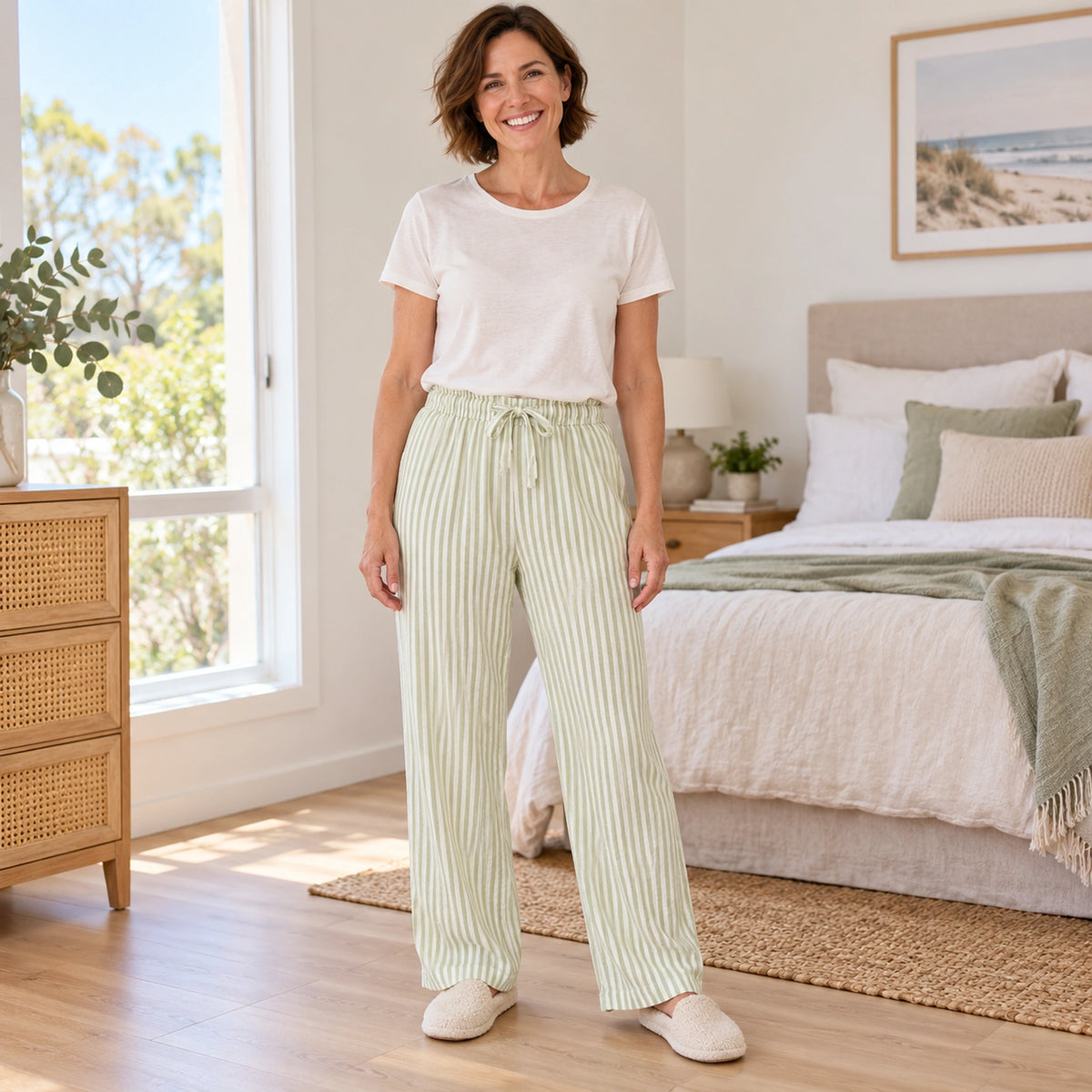 Sage Green Stripe cotton gauze pajama pants, complete front view on mature model at home — view 4