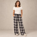Black And White Plaid wide leg pajama pants, complete front view on mature model in a warm neutral