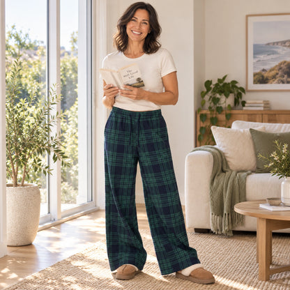 Dark Green Plaid wide leg pajama pants, complete garment on mature model reading by a home living room window — view 8