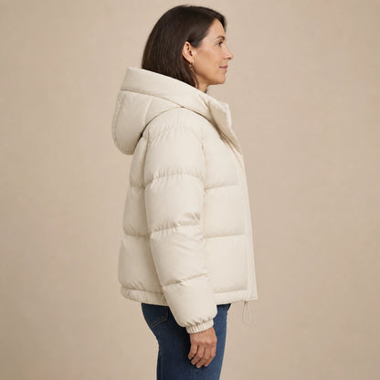 Woman wearing ivory hooded puffer parka coat, complete side view — view 5