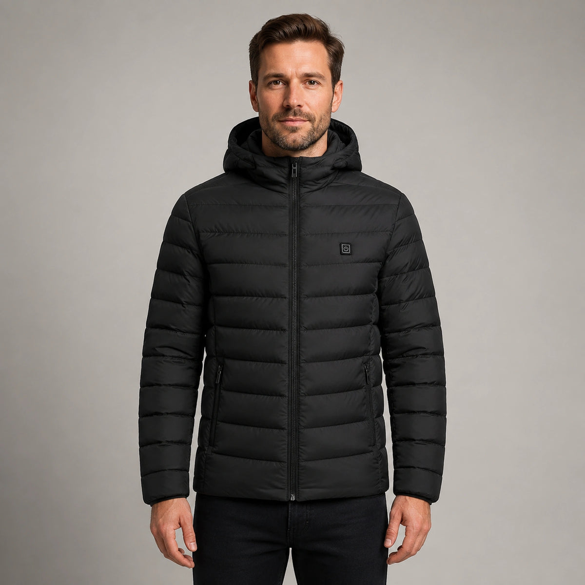 Man wearing black USB heated hooded parka coat, complete front view