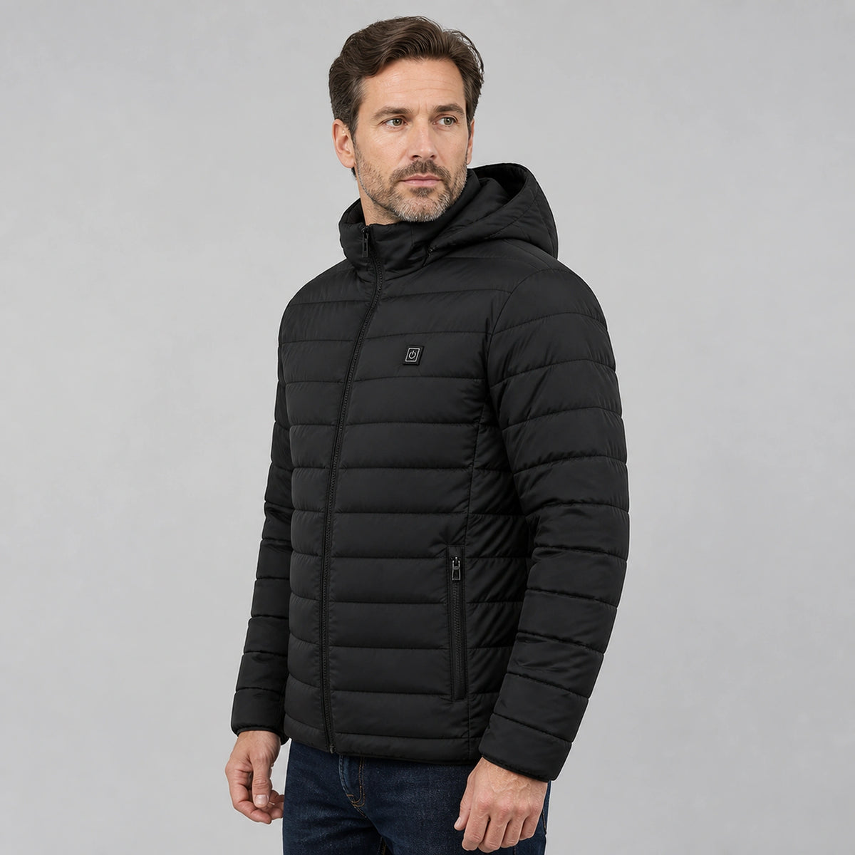 Man wearing black USB heated hooded parka coat, complete side view — view 2