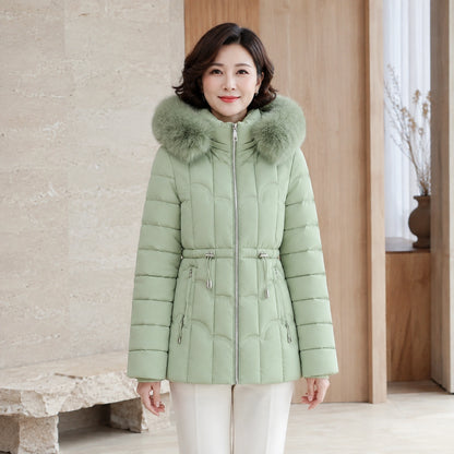 parka coat — Woman wearing sage green faux fur hooded puffer coat, complete front view