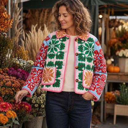Woman wearing the Charlotte folk floral quilted jacket at an autumn flower market — view 5
