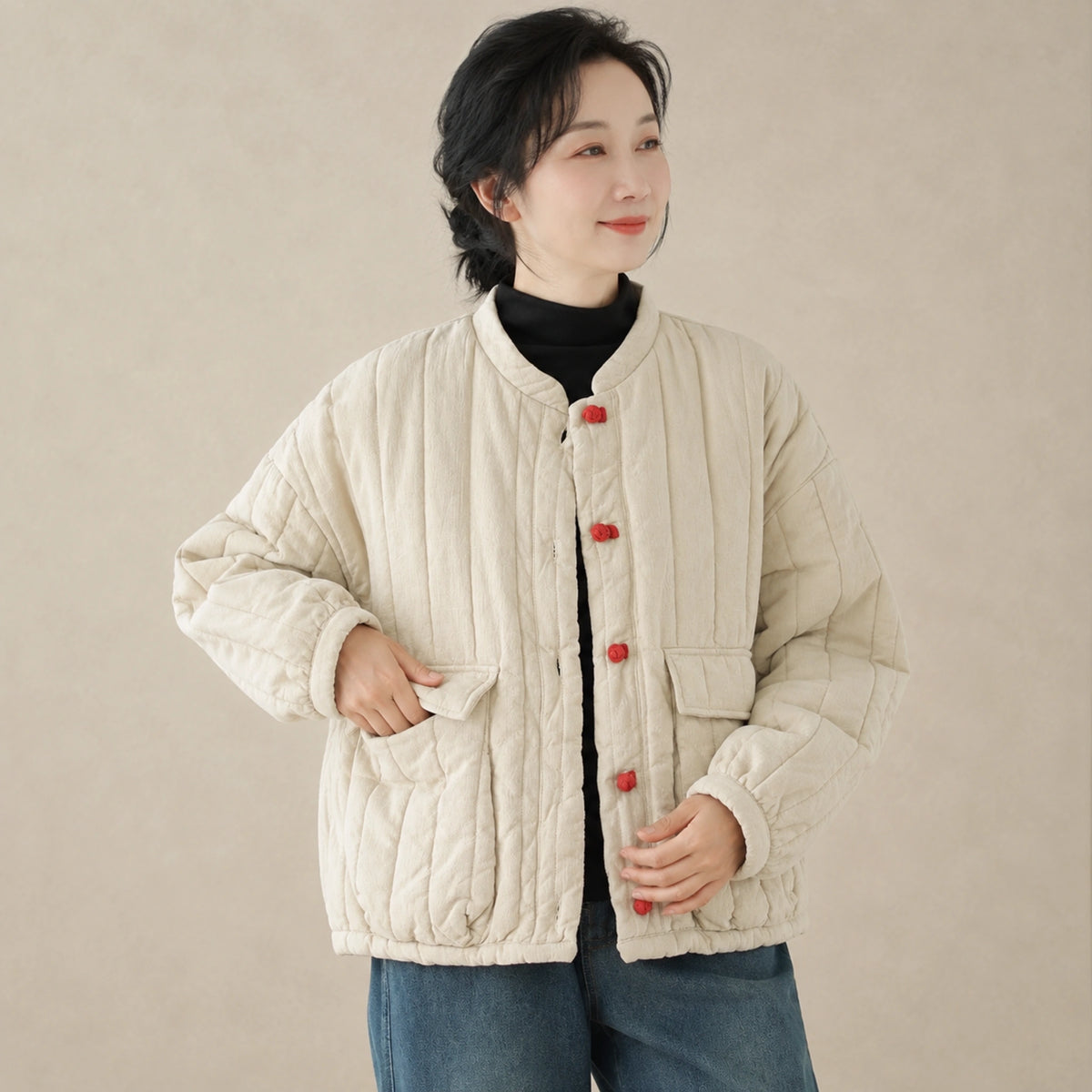 Beige quilted jacket button and pocket detail on a model — view 4
