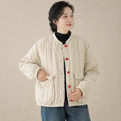 Beige quilted jacket button and pocket detail on a model — view 4