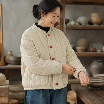 Beige quilted jacket cuff and hem construction detail on a model — view 5