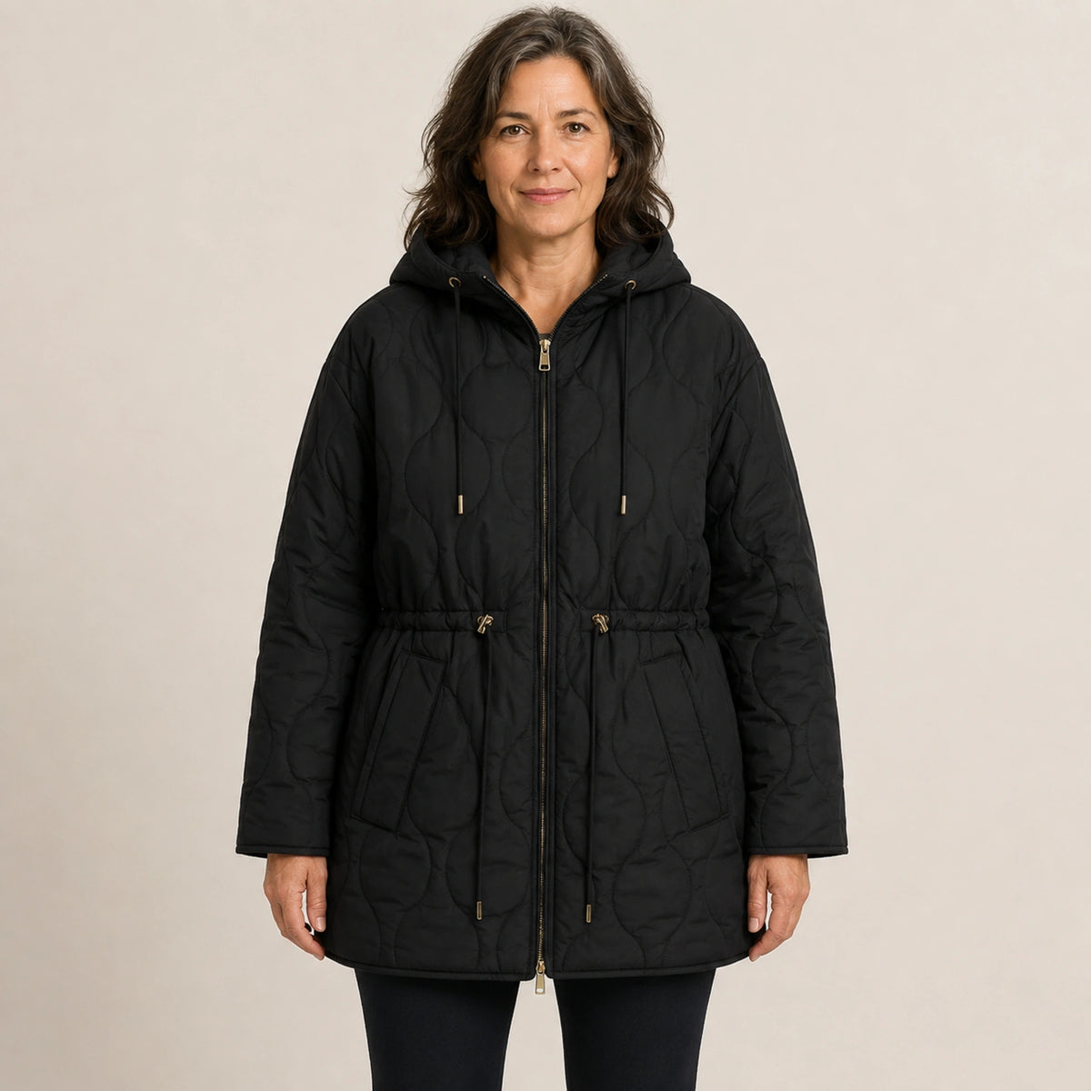 Black hooded longline quilted jacket front view on a model