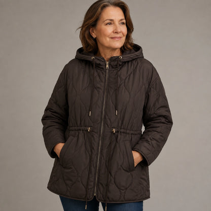 Brown quilted jacket waist and pocket detail on a model — view 6