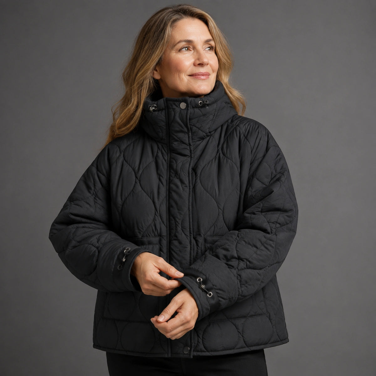 quilted jacket — Black quilted coat cuff construction detail on a model — view 11