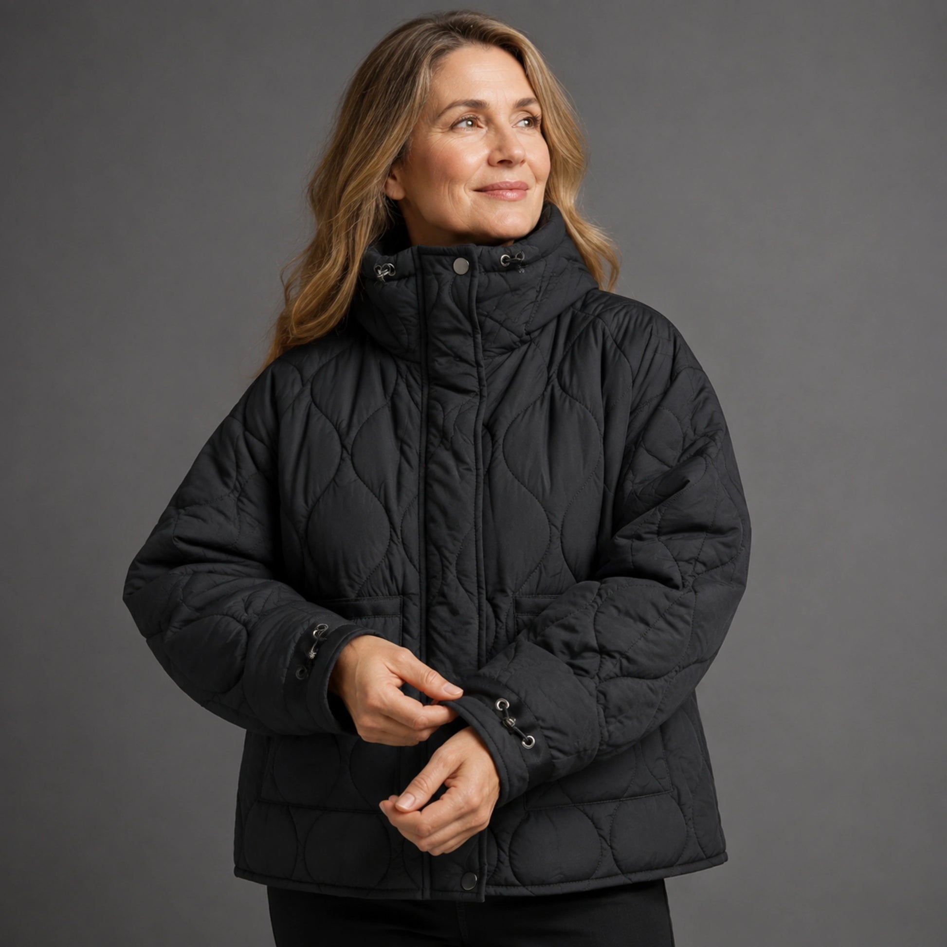 quilted jacket — Black quilted coat cuff construction detail on a model — view 11