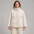 quilted jacket — Beige high neck quilted coat front view on a model