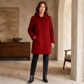 red coat — Stella deep red wool blend coat complete front view on a mature woman