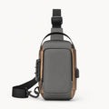 Gray hard shell chest sling bag with Gold Trim complete front view