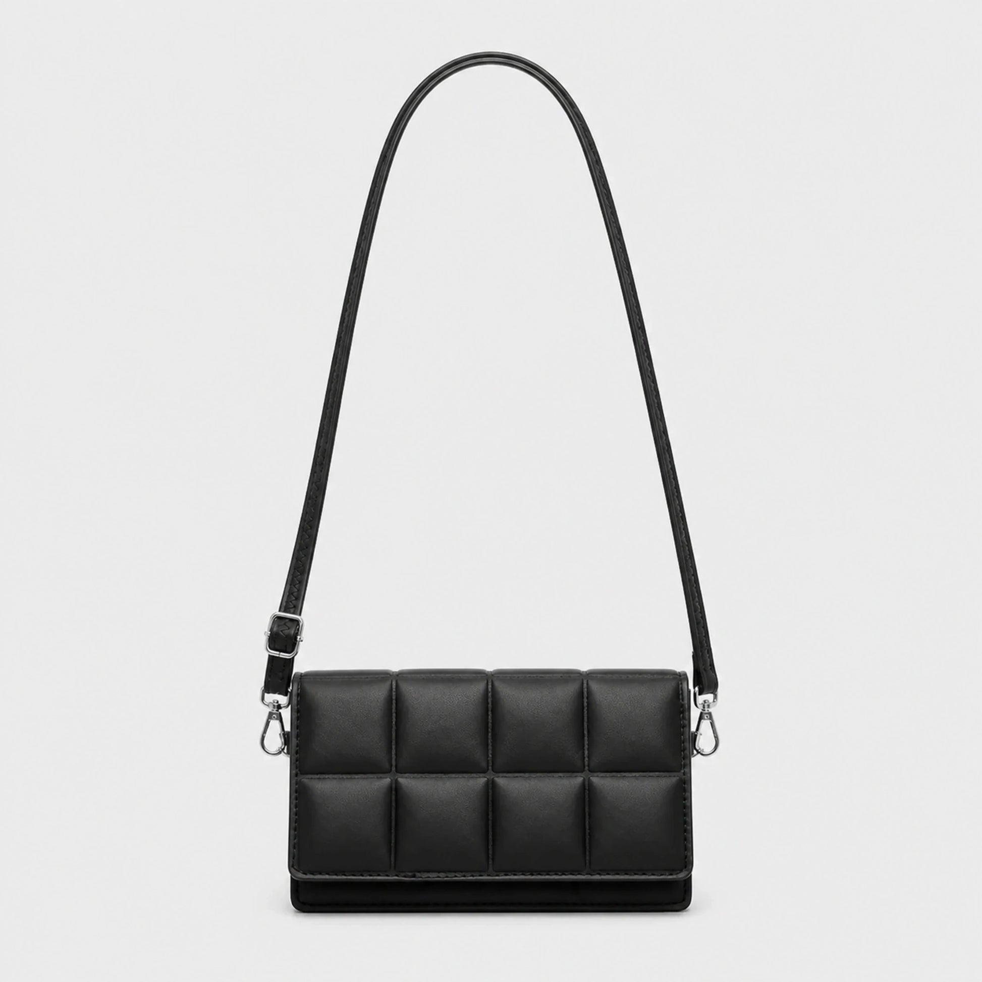 Black quilted sling bag complete front view — view 2