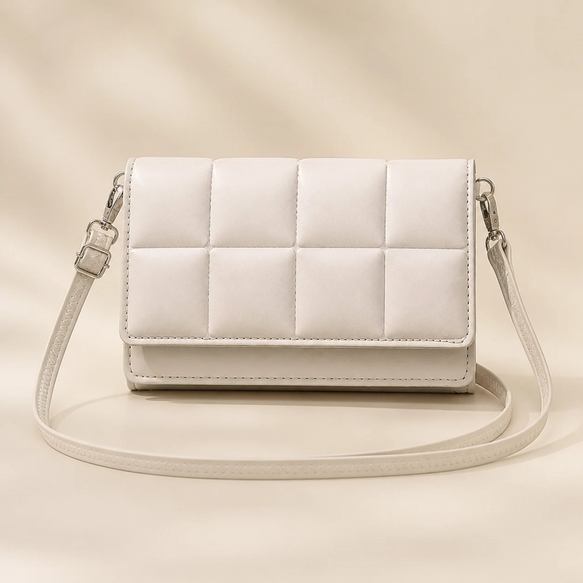 Ivory white quilted sling bag complete front view — view 3