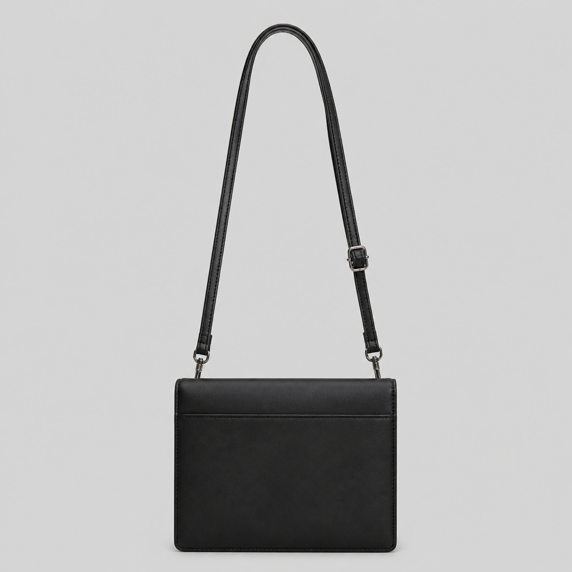 Black quilted sling bag back view — view 4