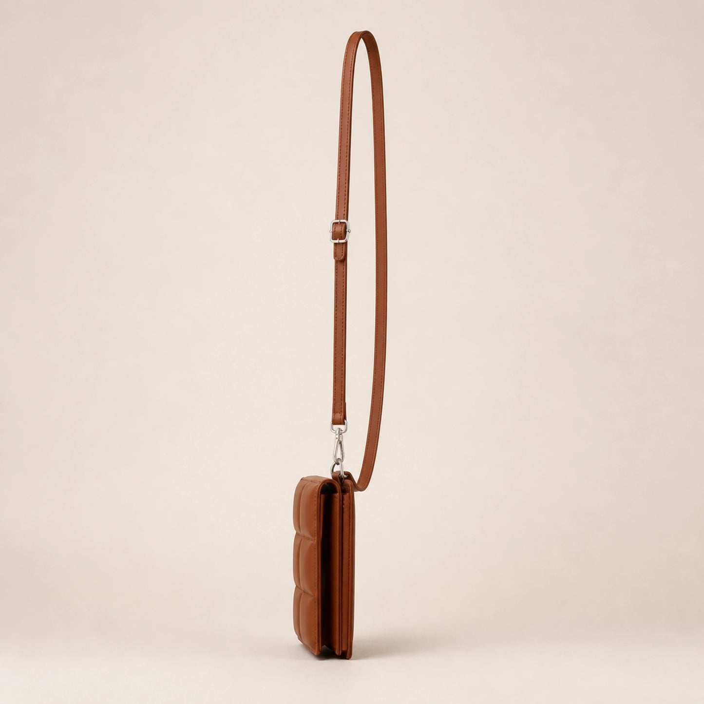 Warm brown quilted sling bag side view — view 5