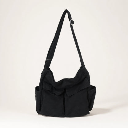 Black vintage multi pocket canvas sling bag complete front view