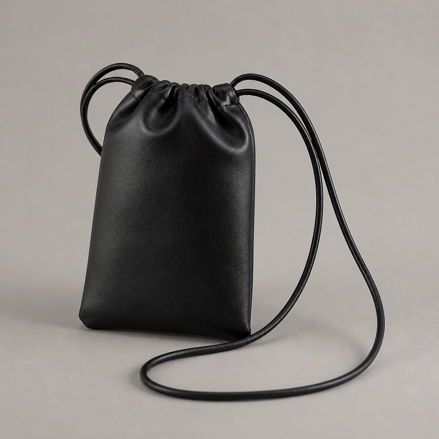 sling bag — Black drawstring sling phone pouch complete front view