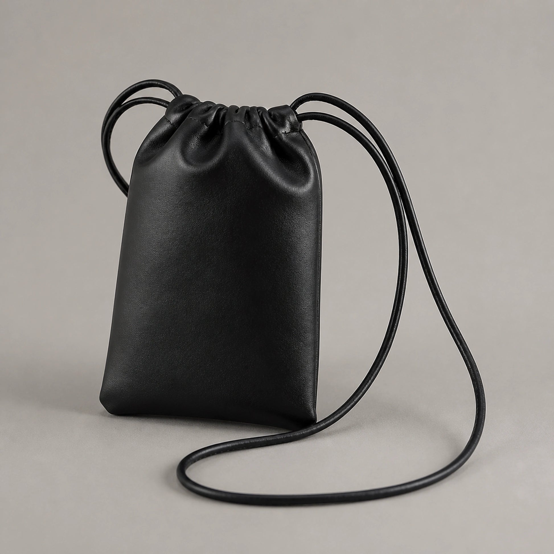 sling bag — Black drawstring sling phone pouch complete front view