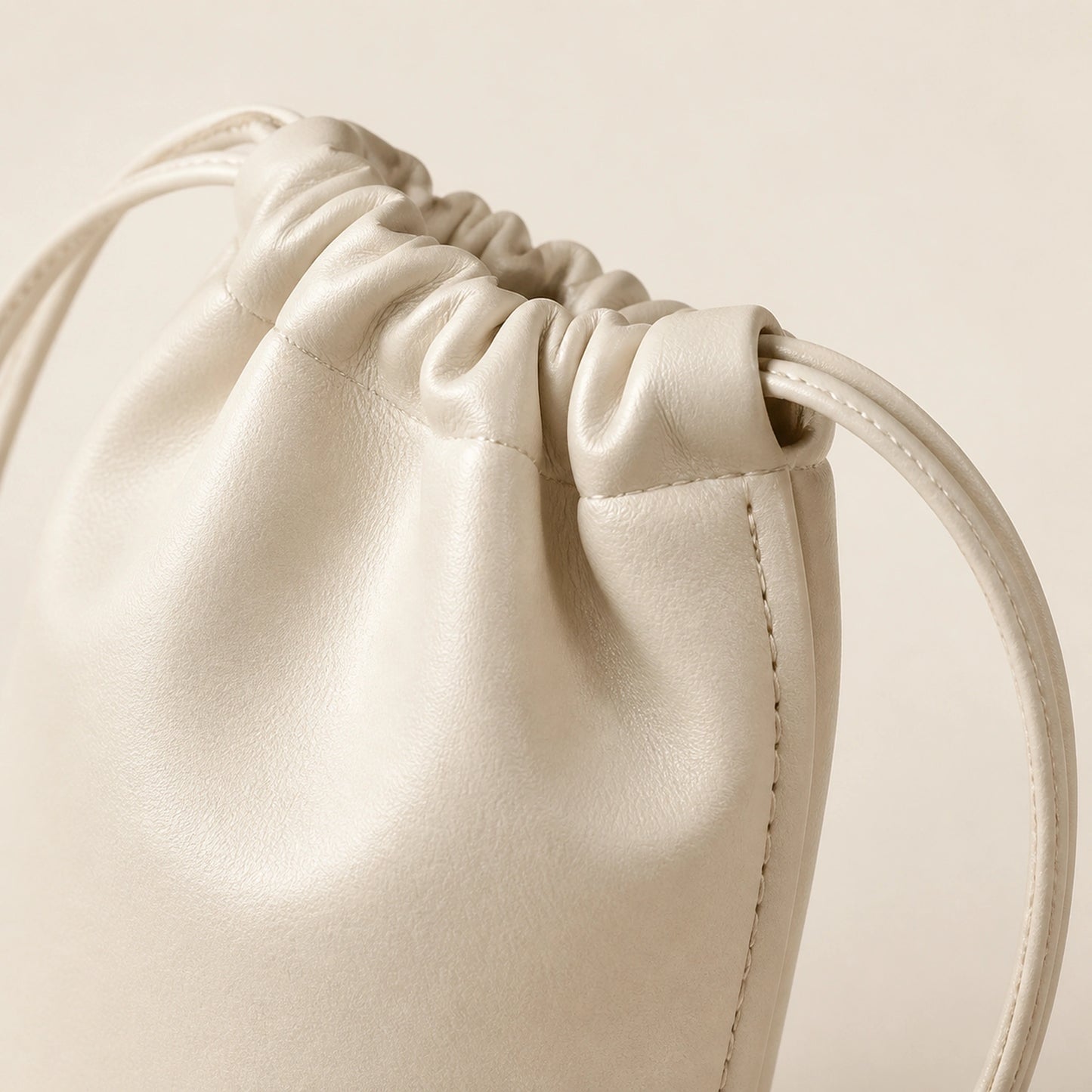 sling bag — Beige drawstring sling phone pouch construction detail — view 10