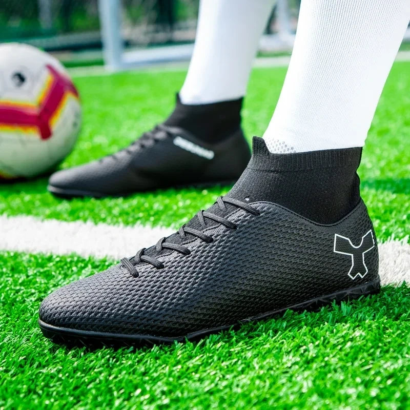 Black soccer cleats with textured surface and ankle support, worn on grass field — view 21 — view 11