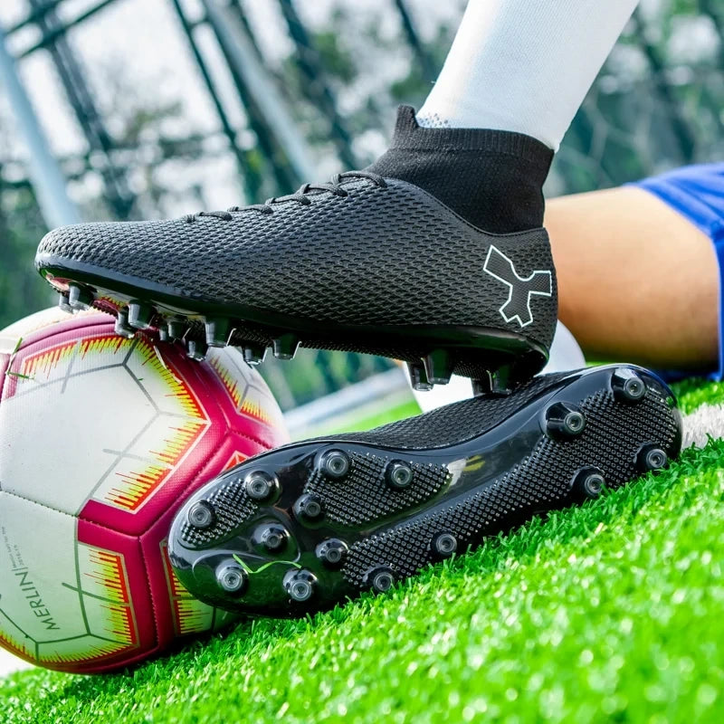 Black soccer cleats with textured surface and rubber studs on grass field — view 4 — view 4