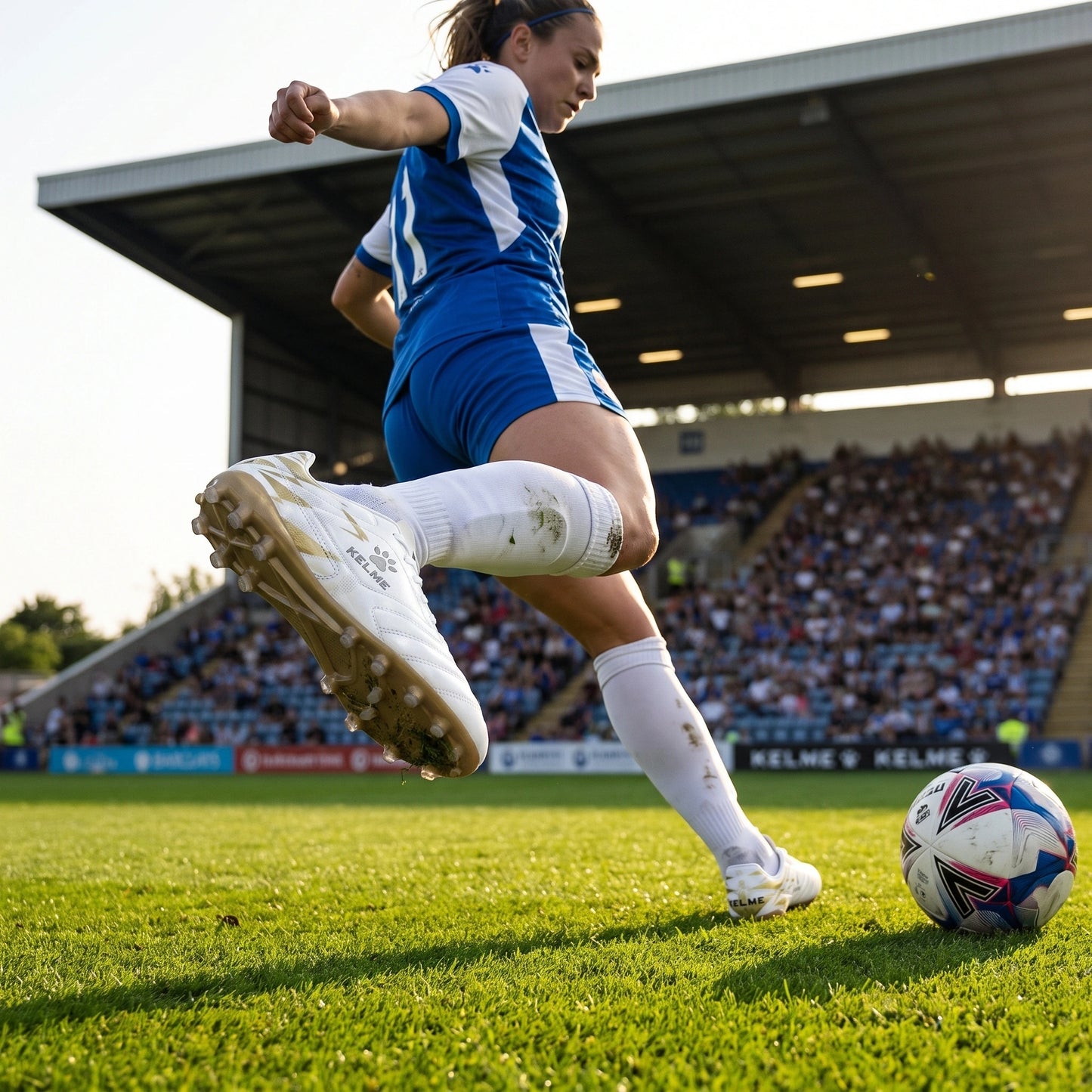 Close up view of the professional short nail soccer cleats showing durable polyester material, intricate stitching — view 3