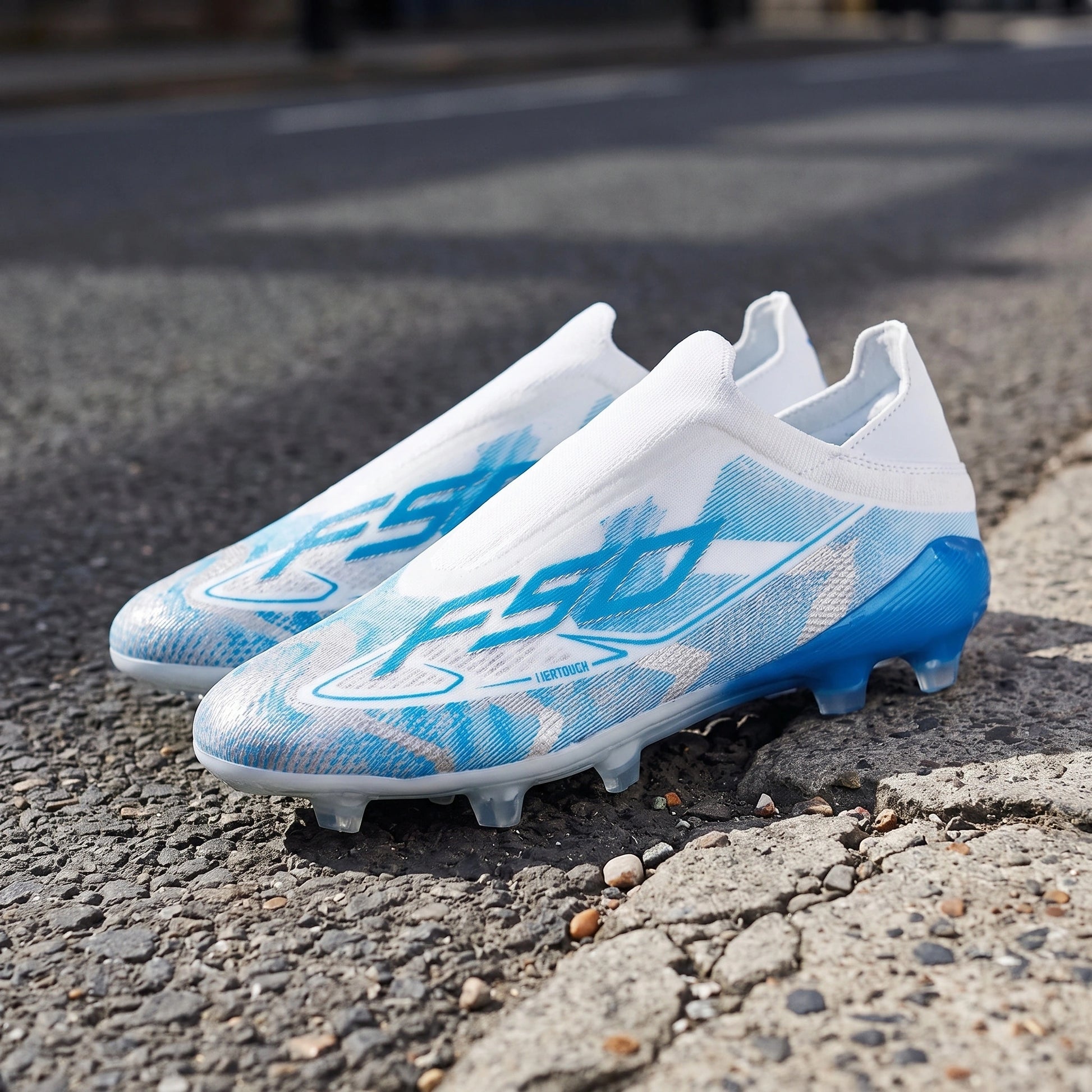 Back view of textured soccer cleats showing the Pu upper and TPU studs, construction details against a neutral — view 2