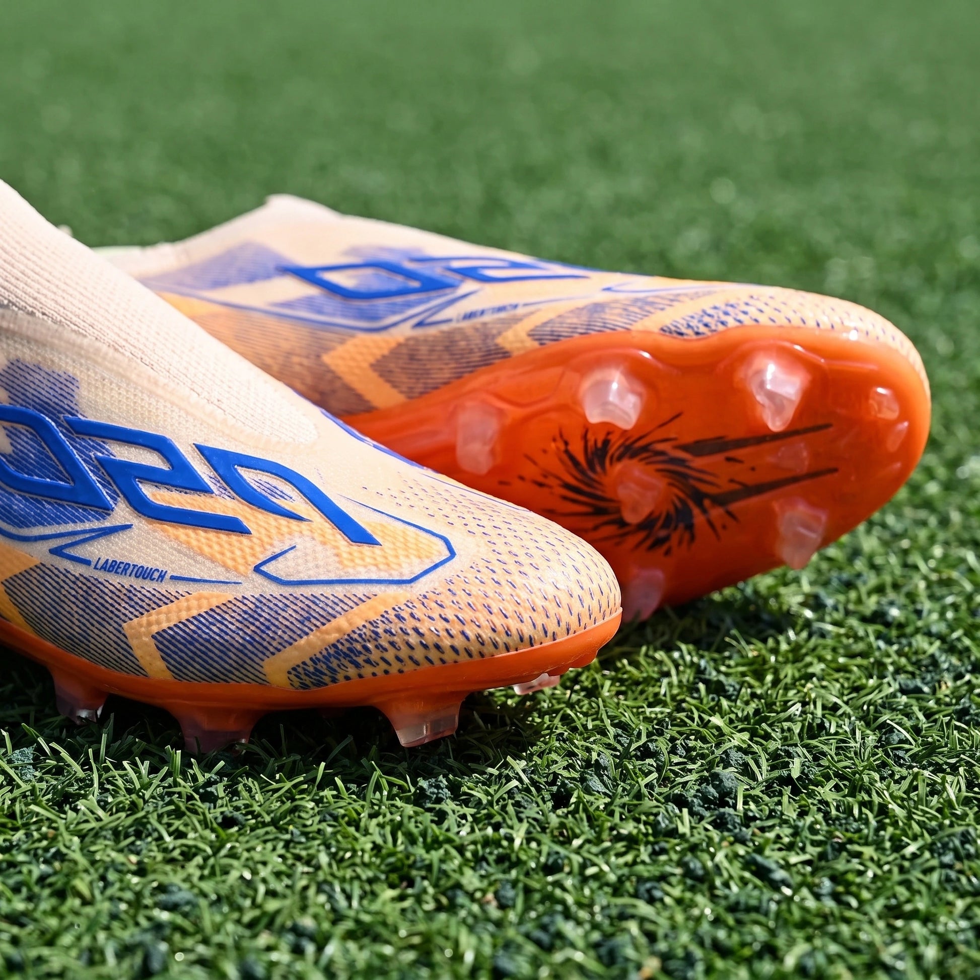 Close up view of the textured Pu upper unisex soccer cleats showing detailed stitching and high friction TPU studs — view 5