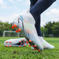White high cut soccer cleats with orange studs and colorful accents on grass field
