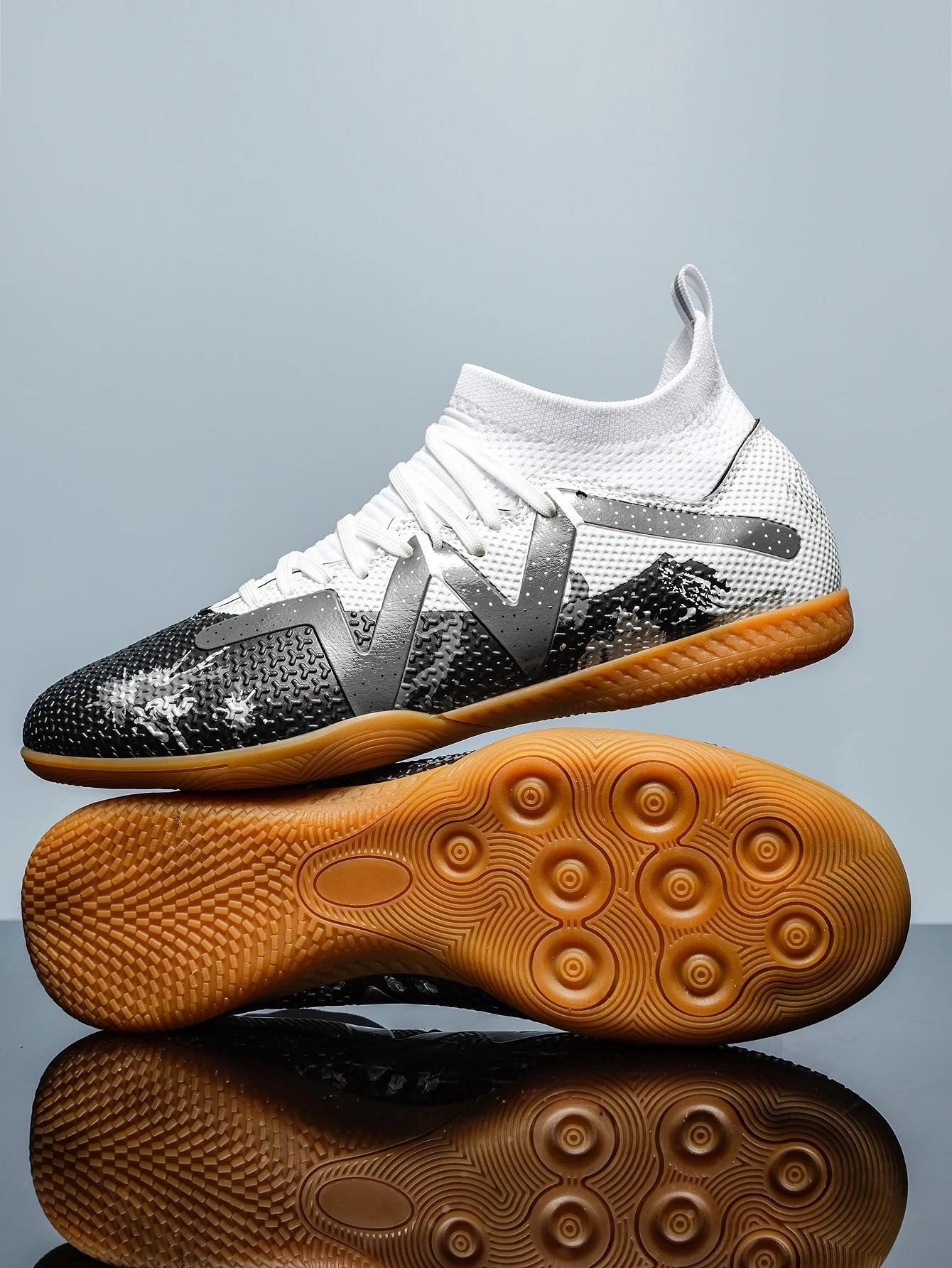 White and black soccer cleats with textured sole lace up design, side view — 16 — view 7