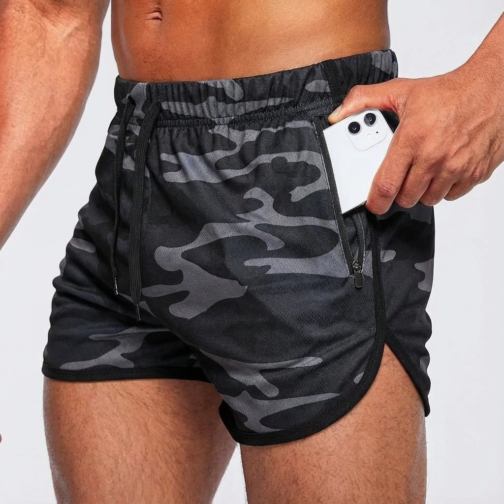 Camouflage soccer shorts with elastic waistband and side pocket, holding a smartphone — view 5 — view 5
