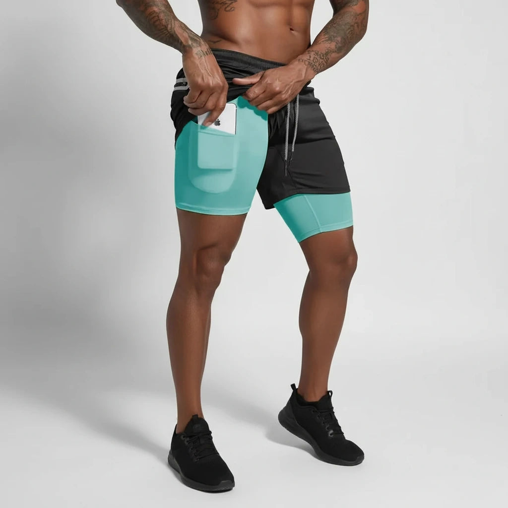 Man wearing black and teal double layer soccer shorts with a pocket, holding phone — view 2 — view 3
