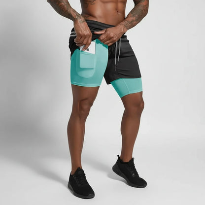 Man wearing black and teal double layer soccer shorts with a pocket, holding phone — view 2 — view 3