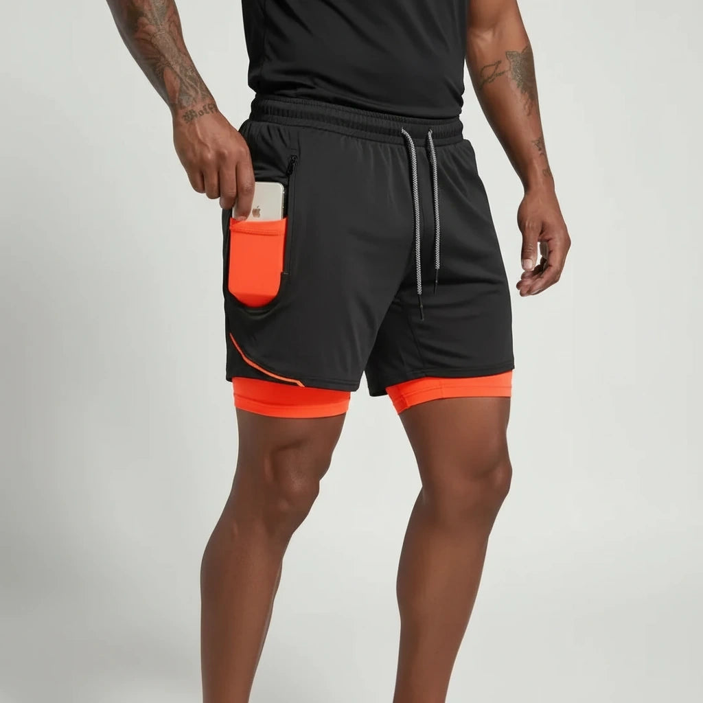 Black and orange double layer soccer shorts with a phone pocket, worn — view 5 — view 4