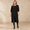 sweater dress — Image; complete full front view; Black maribelle garment worn by a happy adult model