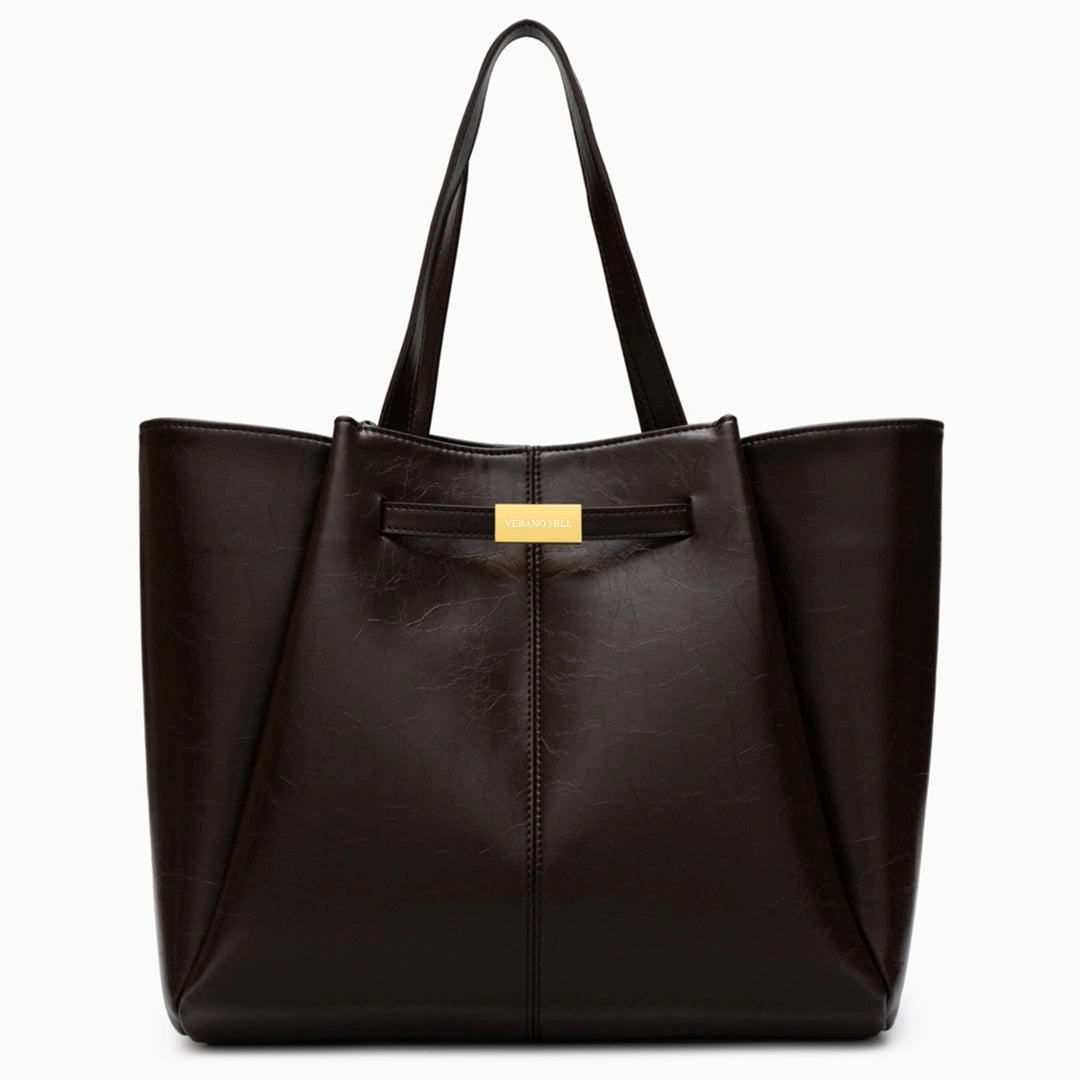 Spacious tote bag in a soft beige fabric, featuring dual handles and roomy interior for everyday essentials
