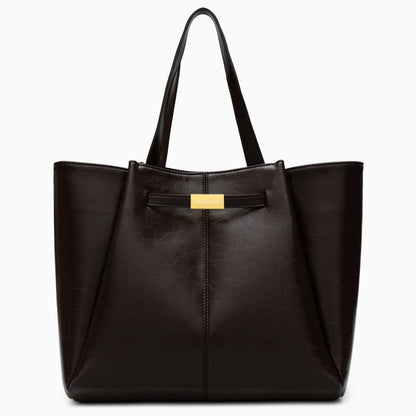 Spacious tote bag in a soft beige fabric, featuring dual handles and roomy interior for everyday essentials