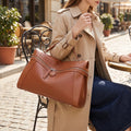 A model showcases the Structured Tote Bag in ensemble showing neutral tones, set against minimalist urban background.