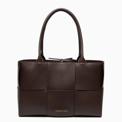 Woven tote bag featuring a chic design, crafted from natural materials in neutral color, top view