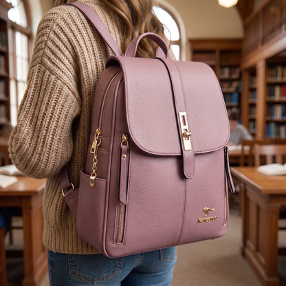 A model showcases spacious leather university backpack in outfit showing white blouse and high waisted jeans against neutral