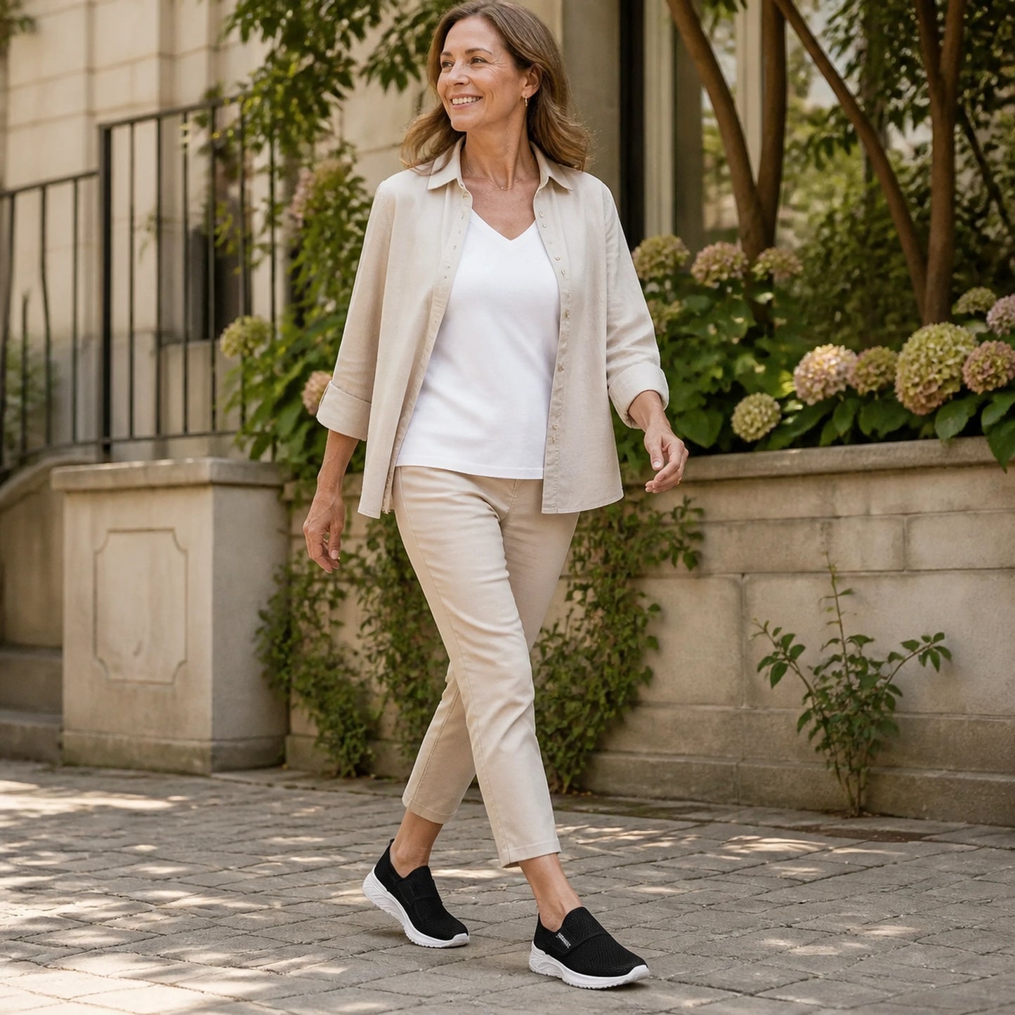 Woman in her fifties wearing black mesh velcro shoes — view 7