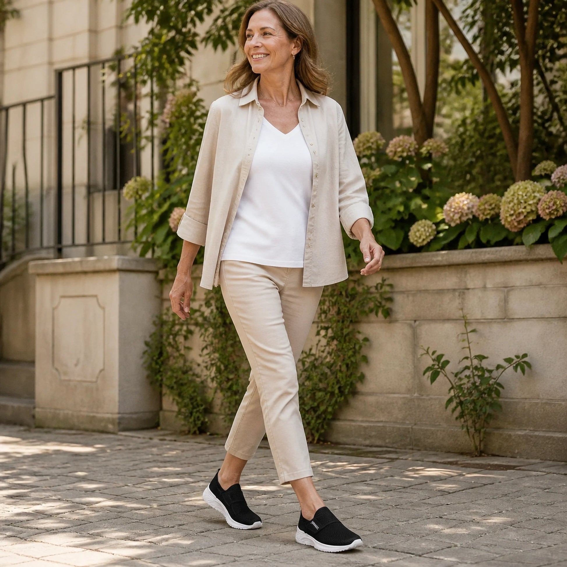 Woman in her fifties wearing black mesh velcro shoes — view 7