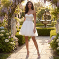 A model showcases stunning white sweetheart line wedding dress, showing fitted bodice and flowing skirt, set against soft