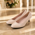 wedding guest shoes — Nude patent low heel wedding guest pumps complete front view